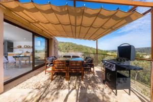 a patio with a table and a grill with a view at Can Jaume in Manacor
