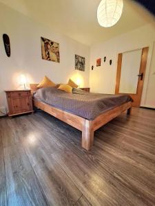 a bedroom with a large wooden bed in a room at Haus am Vogelsang in Hannoversch Münden +24 photos