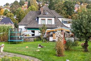 a house with two dogs sitting in the yard at Haus am Vogelsang in Hannoversch Münden