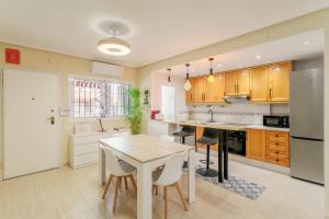 a kitchen with wooden cabinets and a table with chairs at Casa Limón in Puerto Marino