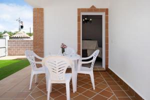 a white table and chairs on a patio at Casa Torre De Meca 2 Shared Pool in Los Caños de Meca