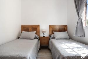 a bedroom with two beds and a window at Casa Torre De Meca 2 Shared Pool in Los Caños de Meca +18 photos