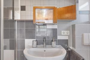 a bathroom with a white sink and a mirror at Ferienwohnung Landliebe in Biederbach Baden-Württemberg +25 photos