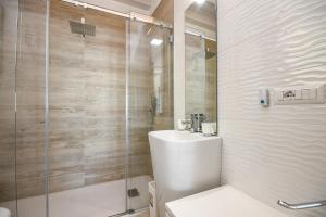 a bathroom with a toilet and a glass shower at Appartamento Luxury 2 in Pulciano +27 photos
