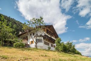 a house on the side of a hill at Woehrmannhof Apt Birnblüte in Feldthurns