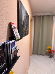a book shelf with books on a wall at Komfort-Apartment Mit Terrasse in Estenfeld
