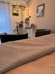 a room with a bed and chairs and a table at Komfort-Apartment Mit Terrasse in Estenfeld