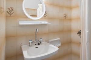 a bathroom with a sink and a mirror at Hotel Galini in Kalymnos +37 photos