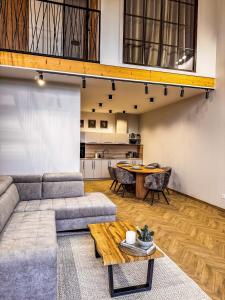 a living room with a couch and a table at Amber loft 12 Rusnė in Rusnė