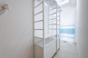 a bathroom with white shelves and a ladder at La casa dei naviganti in Villasimius