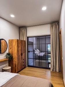 a bedroom with a bed and a large glass door at Amber loft 12 Rusnė in Rusnė