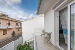 a balcony with a table and a chair on it at La casa dei naviganti in Villasimius