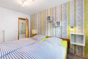 a bedroom with a bed and a tv on the wall at Fewo im sonnigen Kaiserstuhl in Endingen
