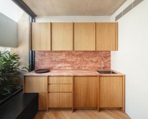 a kitchen with wooden cabinets and a sink at Stilla, San Mikiel in Senglea +17 photos