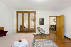 a white room with a bed and a mirror at Casa De Santo Amaro in Carrazedo +37 photos