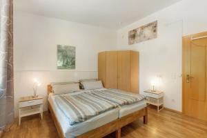 a bedroom with a bed and two night stands at Ferien im Grünen in Mammelzen +14 photos