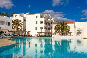 a swimming pool in front of a resort at White sands 613 in Arenal d'en Castell