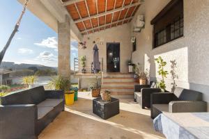 a porch of a house with couches and stairs at Casa De Santo Amaro in Carrazedo