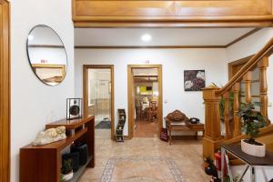 a living room with a staircase and a mirror at Casa De Santo Amaro in Carrazedo