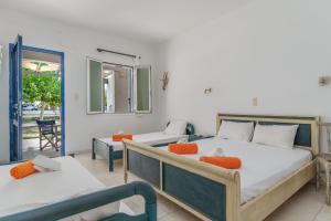 a bedroom with two beds and a balcony at Perasma Studios 9 in Kipri