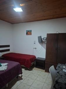 a hotel room with two beds and a tv at Hostal AMALAYA in Salta
