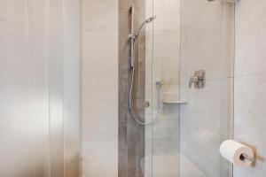 a bathroom with a shower with a glass door at Harmony room in Piano