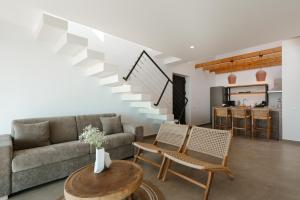 a living room with a couch and a table at River Villas Plomari - Luxury Villas with Direct Pool Access in Plomari