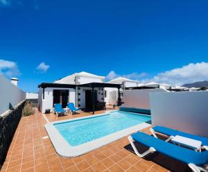 a swimming pool on the roof of a house at Villa Gauda in Lanzarote
