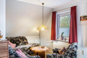 a living room with a couch and a table at Heidis Fewo in Hohenkirchen