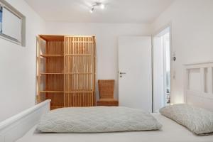 a bedroom with a bed and a book shelf at Bachblick in Buchenbach