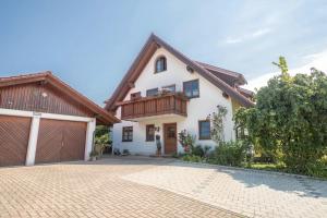 a white house with a brown roof at Haus Desor in Kressbronn am Bodensee