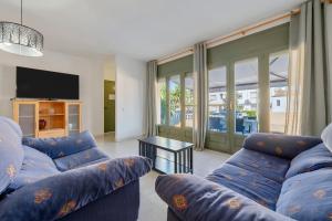 a living room with two blue couches and a table at La Terraza in Riumar