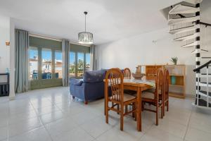 a dining room with a table and a blue couch at La Terraza in Riumar