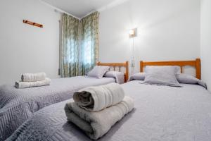 a bedroom with two beds with towels on them at La Terraza in Riumar +18 photos