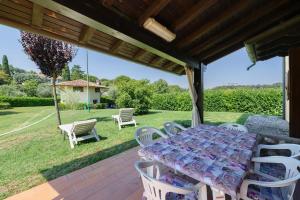 a table and chairs on the patio of a house at Residenza Le Paolette con piscina in Padenghe sul Garda