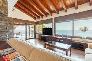 a living room with a couch and a television at Villa con Infinity pool in Lloret de Mar