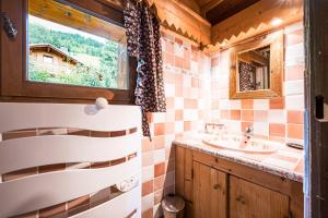 a bathroom with a sink and a mirror at Chalet Farapreu in Manigod +22 photos