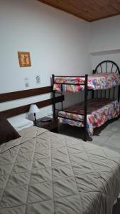 a bedroom with two bunk beds and a table at Hostal AMALAYA in Salta +11 photos