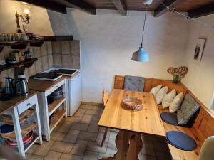 a kitchen and dining room with a wooden table at Casa Piccola in Falmenta