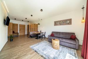 a living room with a couch and a table at Paflur Lodges Abendrot in Lasa