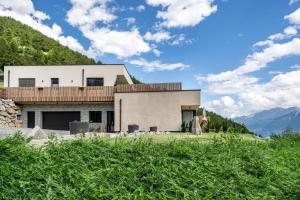 a house on a hill with mountains in the background at Paflur Lodges Abendrot in Lasa