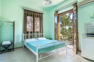 a bedroom with a bed and a balcony at Old Boat double studio 4 in Nikiana