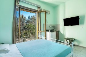 a bedroom with a bed and a balcony at Old Boat double studio 4 in Nikiana