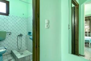 a bathroom with a shower and a toilet and a sink at Old Boat double studio 4 in Nikiana +12 photos