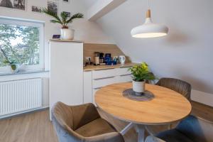 a kitchen with a wooden table and some chairs at Hue Space Air in Kassel