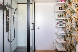 a bathroom with a shower and a glass door at Hue Space Air in Kassel