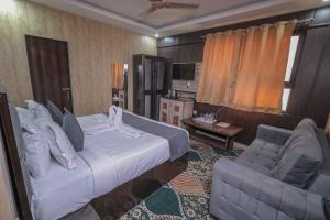 a hotel room with a bed and a chair at Tulsi Garden- Near Prem Mandir Vrindavan in Vrindāvan