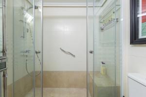 a shower with a glass door in a bathroom at Cute apartment oceanfront in Benalmádena +17 photos