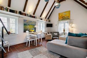 a living room with a couch and a table at Hyggelig Am Deich - Ockholm in Ockholm