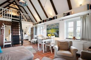 a living room with a couch and a table at Hyggelig Am Deich - Ockholm in Ockholm